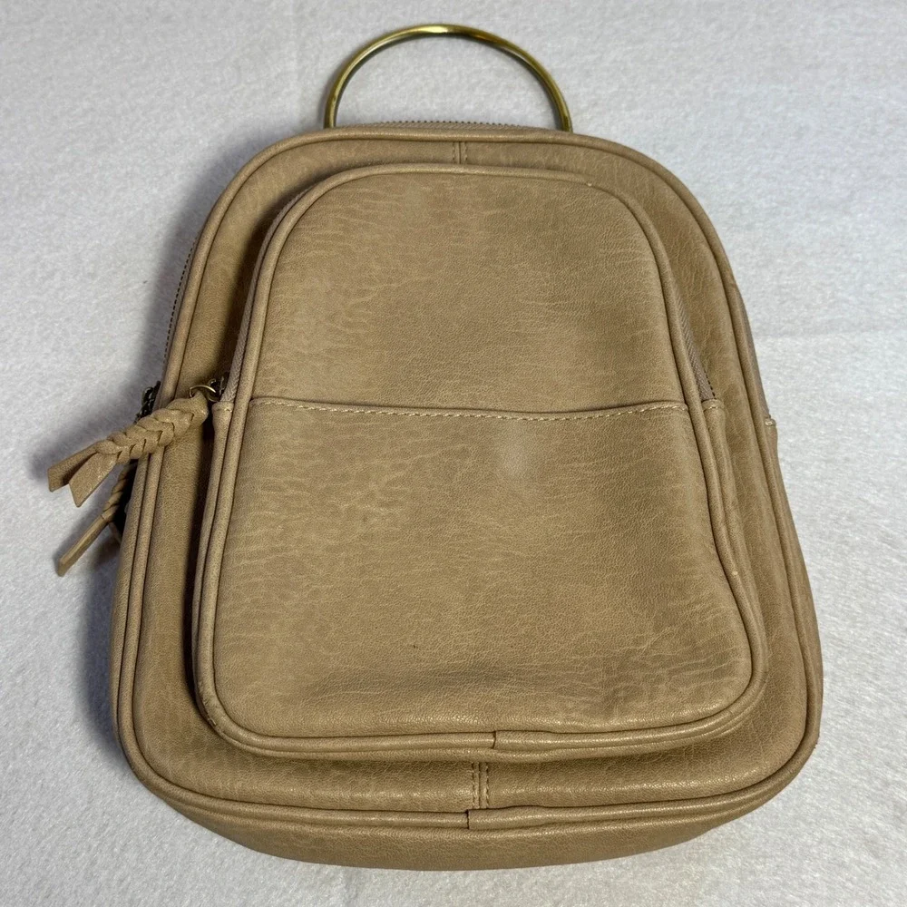 antik kraft faux leather backpack Nyra Webbing Strap Convertible Purse Introducing the Sienna Webbing Strap Convertible Backpack Purse an incredibly versatile piece that takes you from town to trail in stylish ease Taupe Sling Backpack